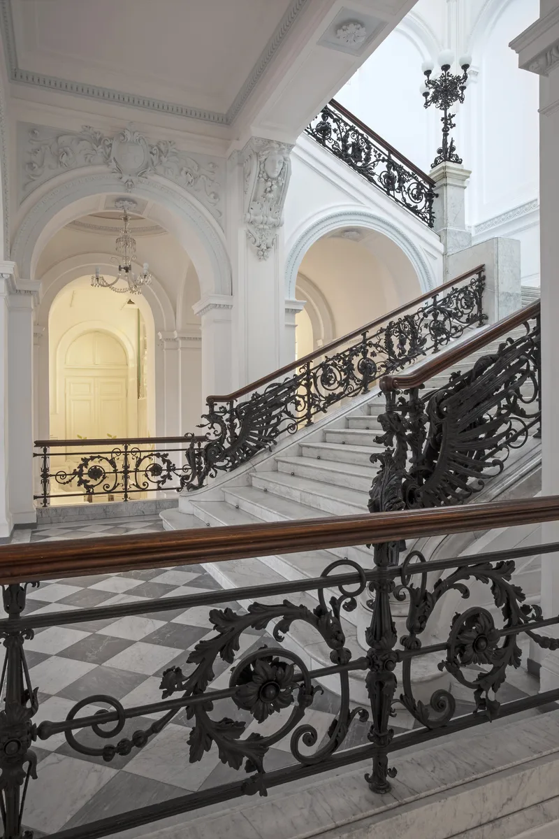 Klatka schodowa Zachety z kutymi zelazem balustradami i sztukateria